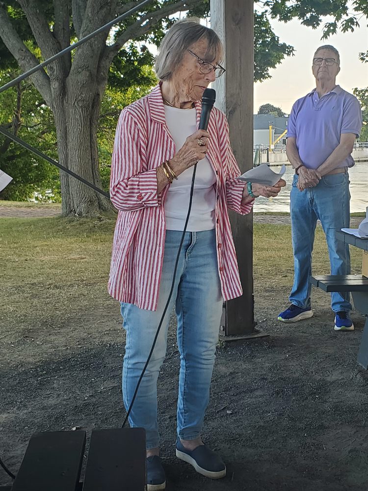 Dudley Dudley reading from a page into the microphone
